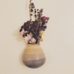 Flowers in a vase on a wall